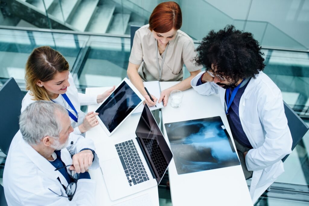 Group of doctors looking at X-ray on medical conference, discussing issues