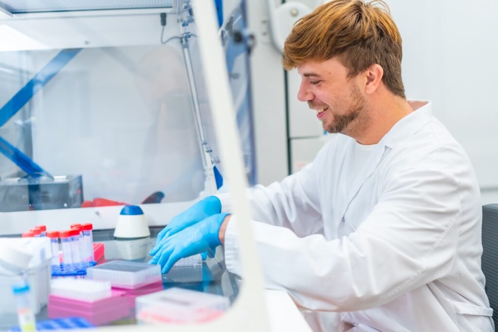 Young scientist working on cells in a cancer research laboratory